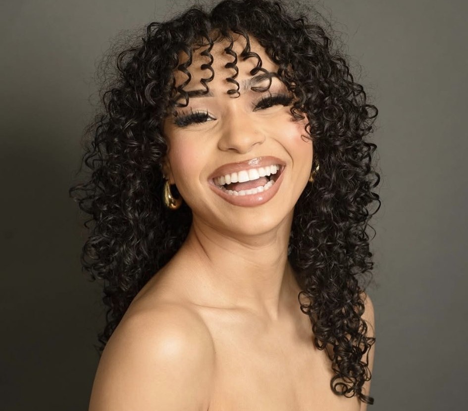 Professional studio portrait of Myracle Brunette smiling